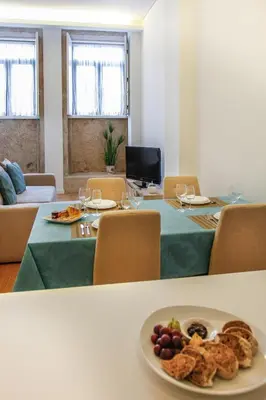 a dining room with a table with a plate of food at Lux Downtown in Porto