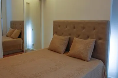 a bedroom with a bed with two pillows and a mirror at Lux Downtown in Porto