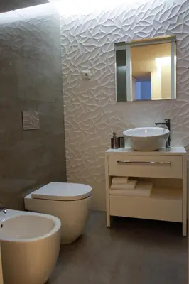 a bathroom with a sink and a toilet and a mirror at Lux Downtown in Porto