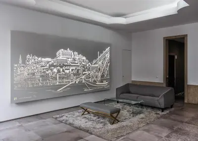 a living room with a couch and a painting on the wall at Lux Downtown in Porto