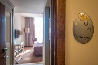 a hotel room with a sign on the wall at Vila Gale Porto Ribeira in Porto