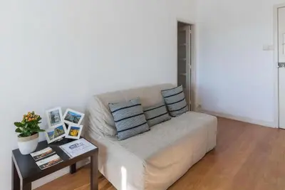 a white couch in a living room with a table at Apartment Cozy 4YOU in Porto