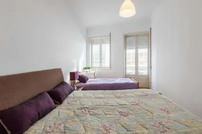 a bedroom with a large bed and a window at Apartment Cozy 4YOU in Porto
