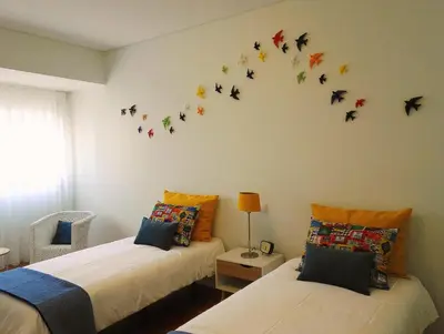 a bedroom with two beds with butterflies on the wall at Always Porto in Vila Nova de Gaia