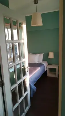 a bedroom with a bed with a blue wall at Porto Downtown Main Str (S.Catarina) + Free Park in Porto