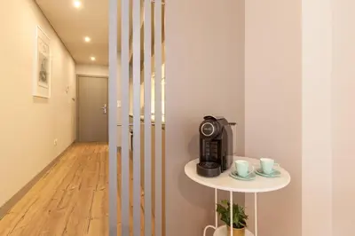 a room with a coffee maker and a table with cups at Sendme2Portugal: Santa Catarina in Porto