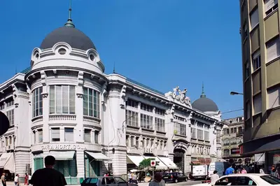 a large white building with domes on a city street at OportoView Alegria Apartment in Porto