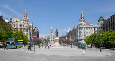 a city street with buildings and a bus at OportoView Alegria Apartment in Porto