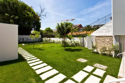 a yard with a stone pathway in the grass at Soulmade Porto in Porto