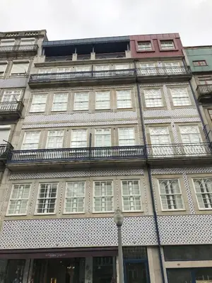 a tall building with windows and a balcony at Oporto Chic&Cozy - Ribeira in Porto