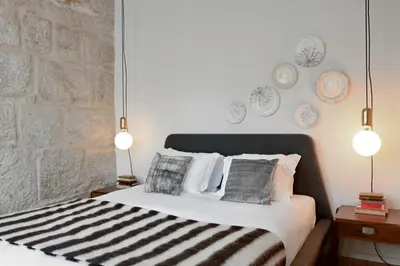 a bedroom with a bed with two lights on it at Oporto Chic&Cozy - Ribeira in Porto