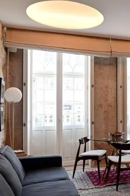 a living room with a couch and a table at Oporto Chic&Cozy - Ribeira in Porto