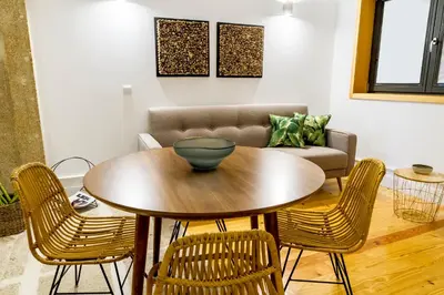 a table and chairs in a living room with a couch at Formosa 178 by Guestify in Porto