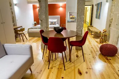 a room with a table and chairs and a bedroom at Formosa 178 by Guestify in Porto