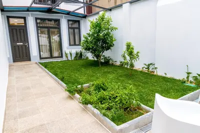 a garden in front of a house with a small tree at Formosa 178 by Guestify in Porto