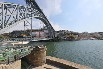 a bridge over a river next to a body of water at FLH Porto Bright Flat in Porto