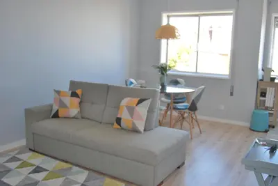 a living room with a couch and a table at Bessa Apartment in Porto