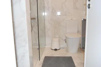 a bathroom with a toilet and a glass shower at Bessa Apartment in Porto
