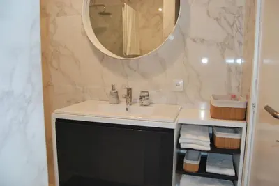 a bathroom with a sink and a mirror at Bessa Apartment in Porto