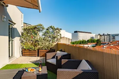 a patio with a table and chairs on a balcony at Music Relaxing Apt with bikes, terrace & parking in Porto
