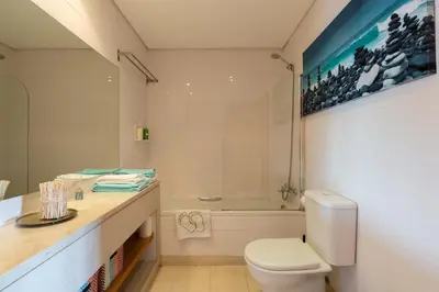 a bathroom with a toilet and a sink and a tub at Music Relaxing Apt with bikes, terrace & parking in Porto