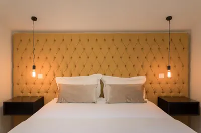 a bedroom with a large bed with two night stands at Santa Catarina Apartments in Porto