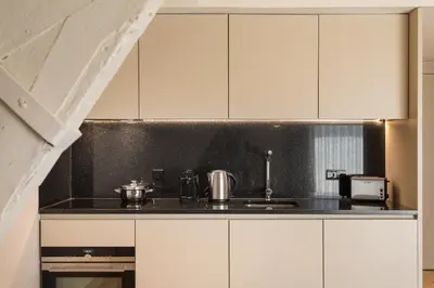a kitchen with white cabinets and a sink at Santa Catarina Apartments in Porto