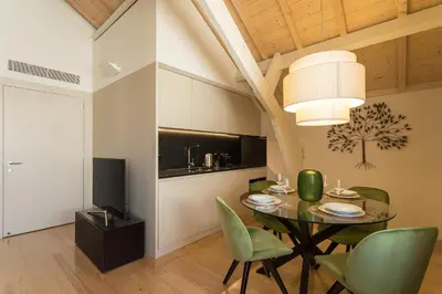 a dining room with a table and green chairs at Santa Catarina Apartments in Porto