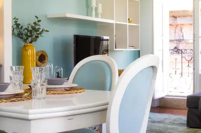 a white dining room table with two white chairs at Liiiving in Porto | Ribeira Boutique Apartment in Porto