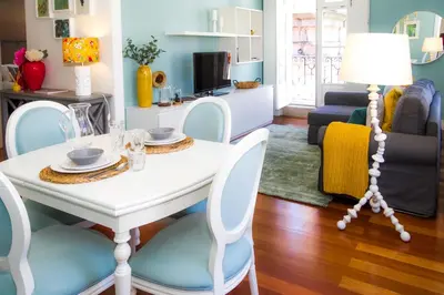 a living room with a white table and chairs at Liiiving in Porto | Ribeira Boutique Apartment in Porto