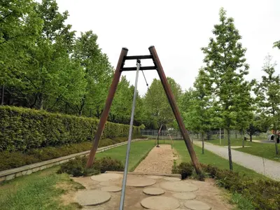 a swing set in a park with trees at Covelo Park Apartment in Porto