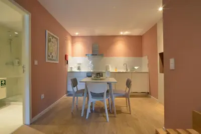 a kitchen and dining room with a table and chairs at Spot Family Apartments in Porto