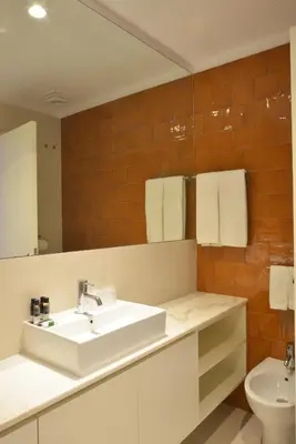 a bathroom with a sink and a toilet at Spot Family Apartments in Porto