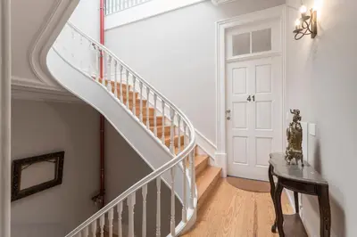 a staircase in a home with a white stair case at Ribeira Historic Apartments in Porto