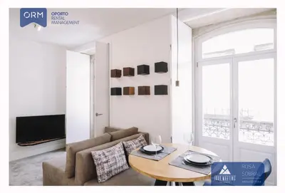 a living room with a table and a couch at ORM - Almada Apartments in Porto