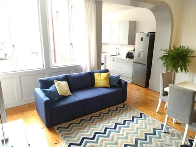 a hallway with stairs and a yellow door at Lusitania Garden Apartment - Jardim Privado in Porto
