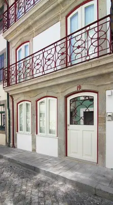 two white doors with the numbers on a wall at HM - Pinheiro Cosy Apartment in Porto