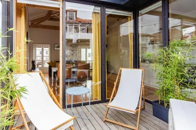 two chairs and a table on a balcony with plants at Amazing Penthouse Apartment in historic Porto in Porto