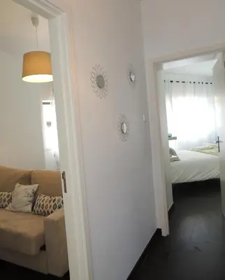 a living room with a couch and a mirror at Rendez Vous Porto in Porto