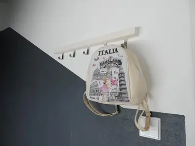 a bag hanging on a wall next to a staircase at Rendez Vous Porto in Porto