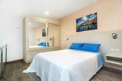 a bedroom with a large white bed and a mirror at Maredimo Village Porto Casa 1 in Porto