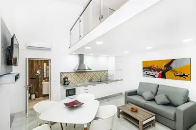 a living room with a couch and a table at Maredimo Village Porto Casa 1 in Porto