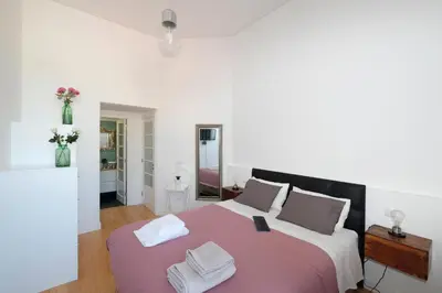 a bedroom with a large bed with two towels on it at Porto Duke's House in Porto