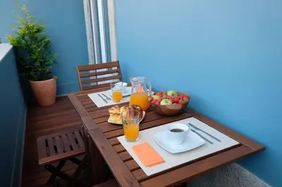 a wooden table with a plate of food and drinks at Porto Duke's House in Porto