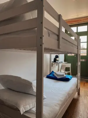 a bedroom with two bunk beds and a desk at Panorama Apartments Ribeira Porto in Porto
