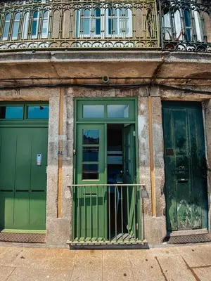 two green doors on the side of a building at Panorama Apartments Ribeira Porto in Porto