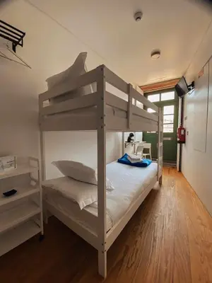 a bedroom with a bunk bed and a desk at Panorama Apartments Ribeira Porto in Porto