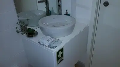 a bathroom with a white sink on a counter at Oporto Cosy Apartment at Alegria in Porto
