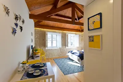 a room with a bed and a table in it at Ribeira Stay Apartments in Porto