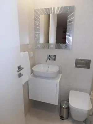 a bathroom with a sink and a toilet and a mirror at BC Porto Downtown Apartment in Porto